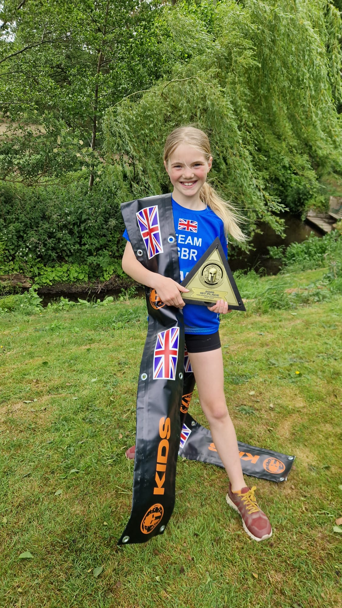 Harry and Sophie holding the Spartan Kids European Championship banner